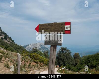 Genna Silana pass, Urzulei, Sardinia, Italy, September 19, 2020: View of tourist guidpost at start of hiking trail to Gola Su Gorropu gorge at green l Stock Photo