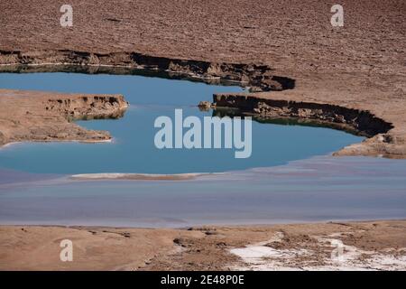 View of sinkholes also known as dolines or cenotes formed by dissolution of underground salt by incoming freshwater, as a result of a continuing sea level drop at the Dead Sea coast in Israel Stock Photo