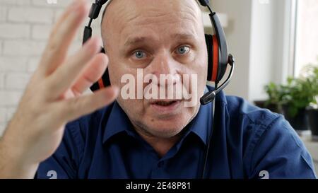 Man Working from Home Talking in a Video Call Using Laptop Connection Stock Photo