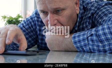Sad Person Isolated in Quarantine Looking Bored and Disappointed to a Cell Phone Stock Photo