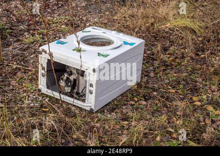 illegal e-waste disposal of a washing machine Stock Photo