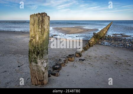 Weathered wooden groynes on the beach of the Baltic Sea in northern Germany, tourist resort landscape, copy space, selected focus, narrow depth of fie Stock Photo
