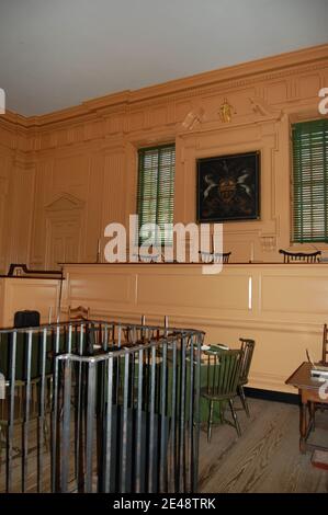 The dock in a Court room in Philadelphia USA prisoner America American wood panelling panel metal chairs prisoner crest shield green blinds chair Stock Photo