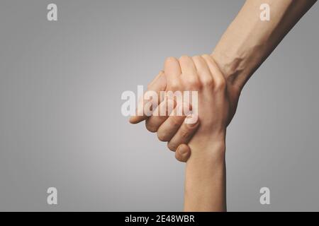 help friend through a tough time. rescue gesture. support, friendship and salvation concept. holding hands Stock Photo