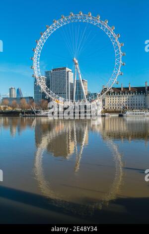 London UK 22 January 2021 A sunny but cold day in  London. The low tide reflecting the London Eye  in the river Thames Paul Quezada-Neiman/Alamy Live News Stock Photo