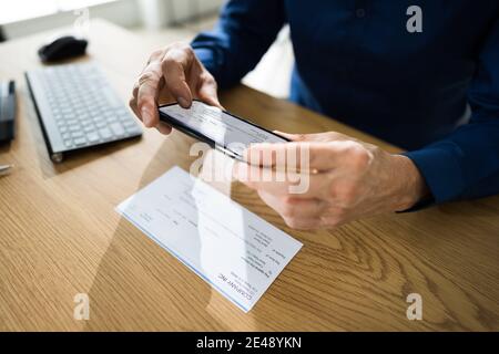 Remote Check Deposit Taking Photo With Mobile Phone Stock Photo