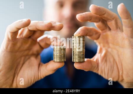Money Disparity And Pay Gap. Comparing Tax And Salary Stock Photo