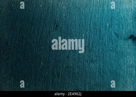 Black slate board on dark stone texture top view. Black textured slate board on dark background Stock Photo