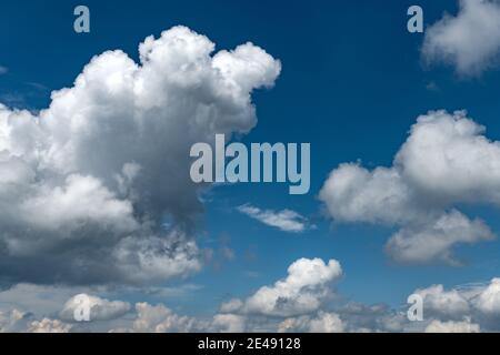 Blue sky background with fluffy clouds Stock Photo