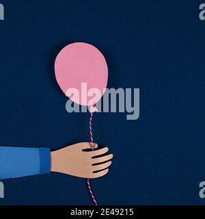 Hand holding a pink paper balloons. Balloons party invitation card. Celebrate events banner posters. Holiday, birthday, valentine concept. 3D Paper ar Stock Photo