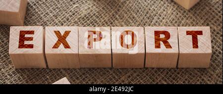 Export Word Written on Wooden Cubes on a burlap background and other wood cubes around. Trade reselling logistics business concept. Stock Photo