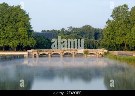 Misty dawn over River Cosson at Chateau de Chambord, Loire Valley, Centre, France
