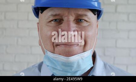Confident Image with an Engineer Smiling and Wearing Face Protection Mask Against Viruses Stock Photo