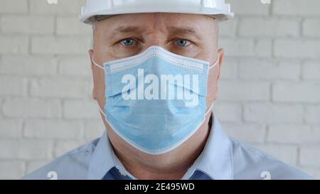 Confident Image with an Engineer Wearing Face Protection Mask Against Viruses. Stock Photo
