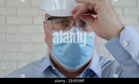 Confident Image with an Engineer Wearing Face Protection Mask Against Viruses. Stock Photo