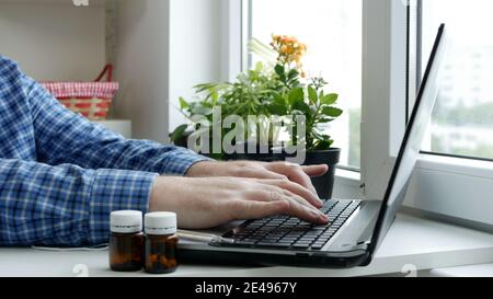 Sick Man Working Remote from Home Using Computer Wireless Connection, Social Distancing Lifestyle in Pandemic Period Stock Photo