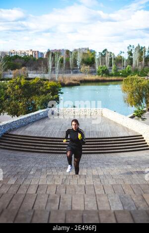 Runner athlete running on stairs. Woman fitness jogging workout concept.  Stock Photo