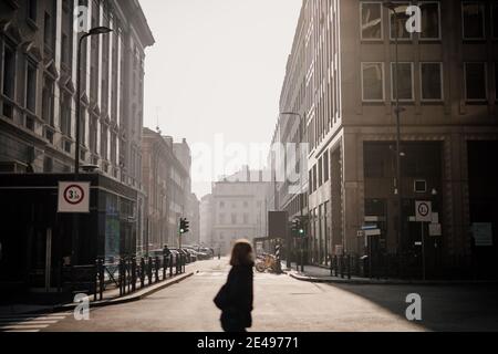 Person in quiet city street during 2020 Covid-19 Lockdown, Milan, Italy Stock Photo