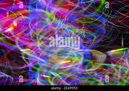 Layered spectrum of bright chaotic colors in light effect created by LED lights photographed outdoors at night. Stock Photo