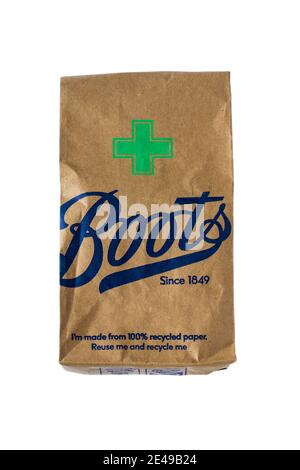 Boots Pharmacy prescription bag now made from 100% recycled paper isolated on white background - reuse me and recycle me Stock Photo