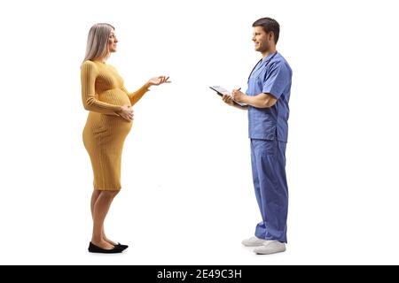 Pregnant woman talking to a doctor with a clipboard isolated on white background Stock Photo