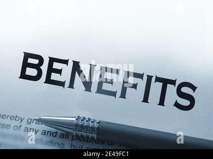 Benefits word printed on page with pen. Insurance or retirement payment social concept. Stock Photo