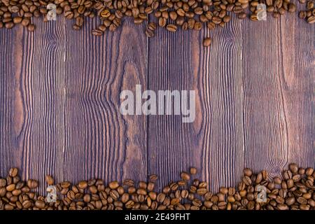 a frame made of coffee beans on a wooden table Stock Photo