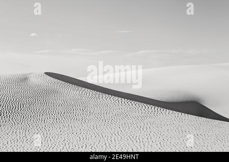 Wave of sand in light and shadow in black and white, White Sands NP. Stock Photo