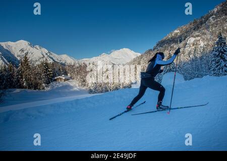 Serina Bergamo Italy 8 January 2021: Girl practicing cross-country skiing on the Conca del'Alben track Stock Photo