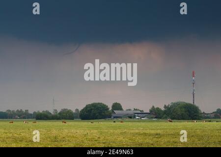 Funnel cloud over the town of Garding in North Friesland, Schleswig-Holstein, Germany Stock Photo