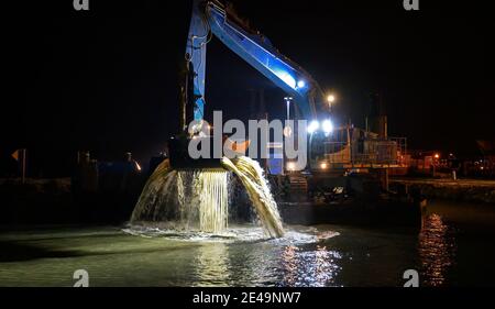 dredger working at the guest harbour of Tulln on the river Danube at night, Austria Stock Photo