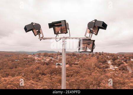 Aerial view of a 4 head sports field lighting structure on a white cloud background Stock Photo