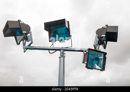 Aerial view of a 4 head sports field lighting structure on a white cloud background Stock Photo