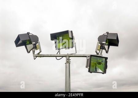 Aerial view of a 4 head sports field lighting structure on a white cloud background Stock Photo