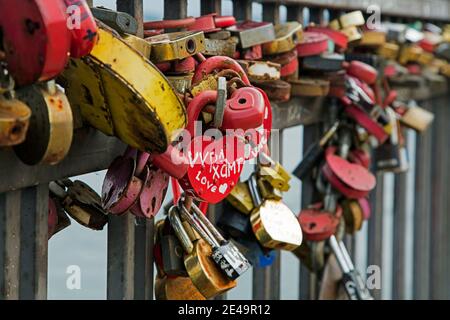 Padlocks on Bridge of Love where married couples hang their padlock and throw away the key in the Angara river in Irkutsk, Southern Siberia, Russia Stock Photo