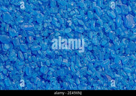 full frame background and texture of blue copper sulfate granules - close-up. Stock Photo