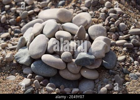 Rocks on the sand beach. Closeup of sand and rocks at a beach Stock Photo