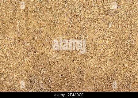 Gold and yellow sand of beach or wall, small pebbles. Texture. Copy space Stock Photo