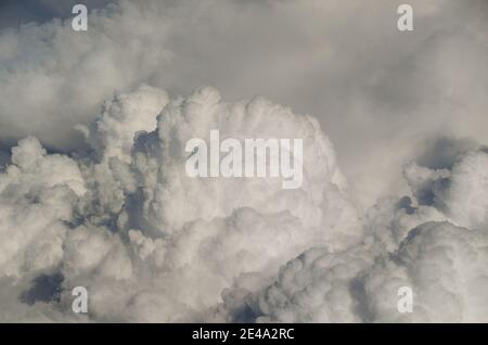 large dense white clouds in the sky view from airplane Stock Photo