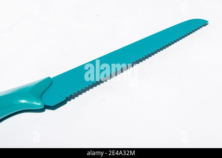 Closeup of a blue bread knife isolated on a white background Stock Photo