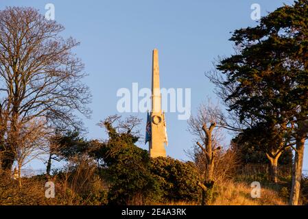 Sunrise at the Southend War Memorial, cenotaph, on the cliffs at Southend on Sea, Essex, UK. Commemorative obelisk glowing from dawn light