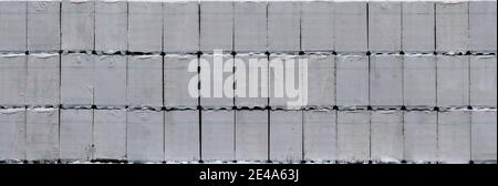 Autoclaved aerated concrete bricks stored on palettes and stacked up, abstract background Stock Photo