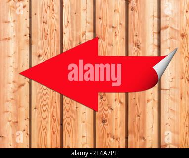 Red left arrow as an illustration on a wooden wall Stock Photo