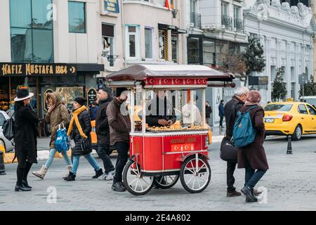 TURKEY, ISTANBUL, DECEMBER 14, 2018: Central Istiklal Street and trolley with Turkish Simits. Stock Photo