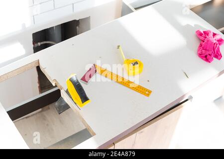 to cut holes in the kitchen countertop for equipment Stock Photo