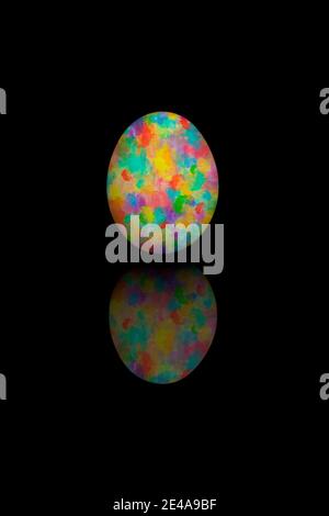 Easter egg painted with different colors, isolated on black bakcground. Stock Photo