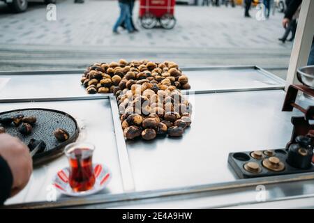 Cooking roasted chestnuts close-up on the street of Istanbul. Stock Photo