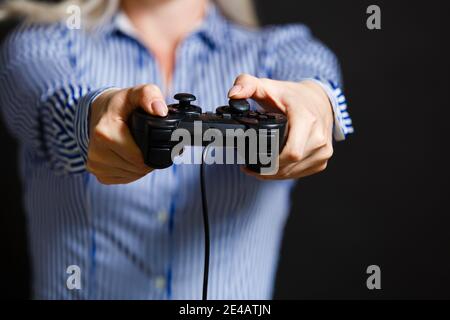 Girl playing video game with joystick. Stock Photo