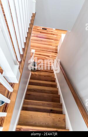 Light pine wood staircase with railing Stock Photo