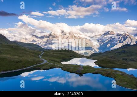 Alp with a mountain lake, in the background the main Alpine ridge Stock Photo